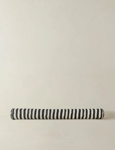 a black and white striped pillow sitting on top of a table