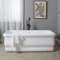 a white bath tub sitting next to a window