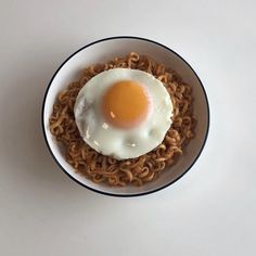 an egg is on top of noodles in a bowl