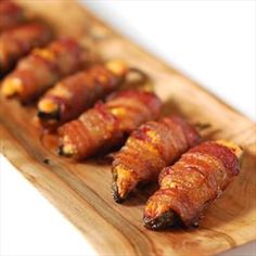 bacon wrapped in strips on a wooden tray