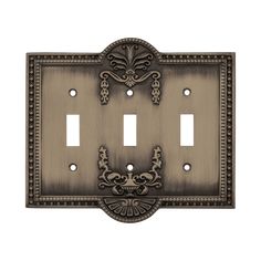 an ornate metal switch plate cover