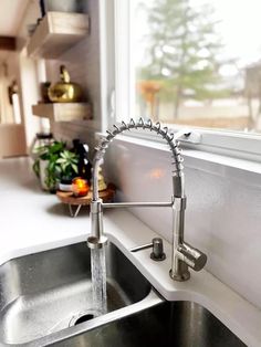 a kitchen sink with a faucet running from it's side spout