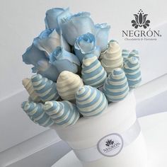 a vase filled with blue and white striped candy