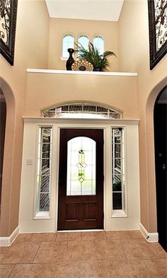 an entry way with two doors and windows