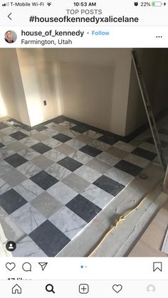 an unfinished room with black and white checkered tile on the floor next to a ladder