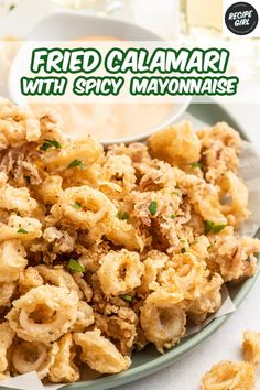 fried calamari with spicy mayonnaise served on a white and green plate