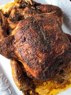 a cooked chicken is on a white plate