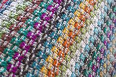 a close up view of a multicolored knitted blanket