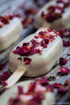 some kind of ice cream with flowers on it and a wooden spoon in the middle