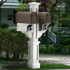 two mailboxes are attached to a white post