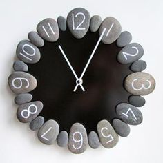 a clock made out of rocks with numbers on it