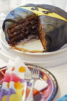 a chocolate cake on a plate with one piece cut out and ready to be eaten