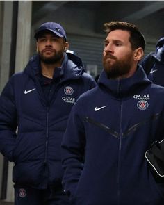 two men in blue jackets are walking together