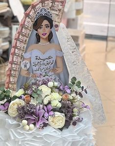 a cake decorated with flowers and a bride figurine