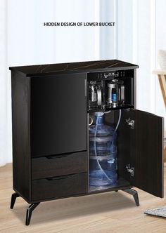 an open cabinet with water bottles in it on a wooden floor next to a chair