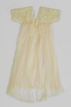 An ethereal vintage 1950s sheer dressing gown in excellent condition by Vanity Fair Lingerie in a size 36. This light & airy style has rose patterned scalloped edge lace at the upper body and sleeves. The entire garment is lined with a sheer tricot nylon (the skirt portion is 2 layers) and trimmed with a dainty 1/2" scalloped lace trim at the bottom hem. Delicate 1/8" satin binding ties are the only closure. Details: Vintage clothing item (excellent condition) Vanity Fair Lingerie Size 36 Pale y Sheer Dressing Gown, Vintage Fitted Ruffle Nightgown, Yellow Nightgown, Vintage Sheer Sleeveless Sleepwear, Picked Flowers, Vintage Sheer Pink Nightgown, Vintage Pink V-neck Nightgown, White Cottage, Scalloped Lace