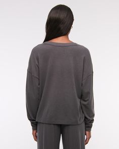 Slim-fitting long-sleeve henley top in our soft cozy lounge fabric and oversized-fit silhouette, featuring a button-up neckline and all-over textured detail. Super Soft Oversized Long Sleeve Sweatshirt, Oversized Long Sleeve Super Soft Sweatshirt, Oversized Super Soft Long Sleeve Sweatshirt, Soft Knit Tops For Loungewear, Versatile Soft Knit Sweater For Loungewear, Versatile Soft Knit Tops For Loungewear, Cozy Long Sleeve Solid Color Tops, Cozy Long Sleeve Solid Tops, Cozy Plain Long Sleeve Tops