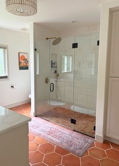 a bathroom with a walk in shower next to a sink