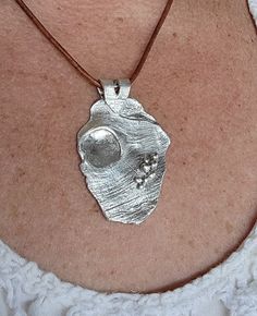 "A fine silver direct imprint of tree bark, creating a beach effect. Fine silver does not tarnish the way sterling silver does, requiring much less maintenance.  This pendant is handcrafted using precious metal clay. This medium is pure silver particles in a bonding material that allows for molding and sculpting.  It is then fired in a kiln to remove all impurities. This allows the artisan to create one-of-a-kind pieces of art.  The cord is leather with a 5\" sterling silver extension. This love Silver Clay Necklace, Silver Clay Pendant, Silver Clay Jewelry Ideas, Metal Clay Designs, Precious Metal Clay Jewelry, Silver Clay, Metal Clay Jewelry, Precious Metal Clay, Pendant Bails