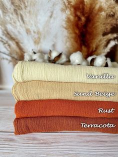 four towels stacked on top of each other with the words vanilla, sand begge, rust terracotta