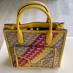 New Ralph Lauren Yellow Multi Color Handbag W Detachable Shoulder Strap. $595. L: 12.5”. H: 12.5”. D: 4”. Luxury Yellow Bag With Top Carry Handle, Yellow Rectangular Bag With Branded Hardware, Yellow Rectangular Bags With Branded Hardware, Designer Yellow Bag With Top Carry Handle, Yellow Travel Bag With Branded Hardware, Luxury Yellow Crossbody Bag, Luxury Yellow Crossbody Satchel, Luxury Yellow Satchel With Gold-tone Hardware, Yellow Shoulder Bag With Branded Hardware For Travel