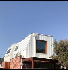 a white building with two windows on the roof