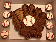 a box filled with cupcakes covered in chocolate frosting and decorated baseball balls