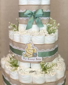 a three tiered diaper cake made to look like winnie the pooh bear