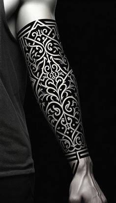 a man's arm with an intricate tattoo design on the forearm and hand, in black