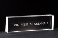 a clear acrylic sign with the words mr mike mendenhall on it