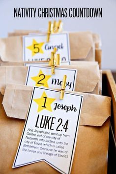 some brown paper bags with tags on them and the words nativity christmas countdown written on them