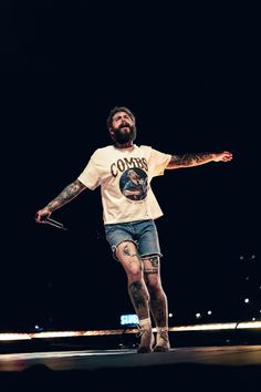 a man with tattoos on his arms and legs