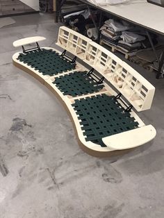 a white bench sitting on top of a hard wood floor