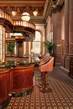 an elegant bar in the middle of a room with checkered flooring and chandeliers