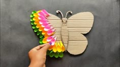 someone is making a butterfly out of paper