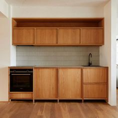 a kitchen with wooden cabinets and an oven