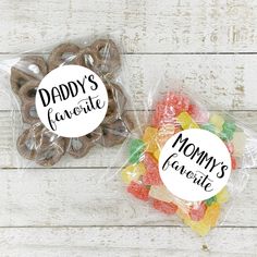 two bags filled with candy sitting on top of a white wooden table next to each other