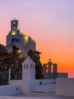 the sun is setting over an old church