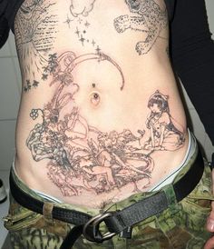 a woman's stomach with tattoos on it