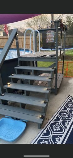 a set of stairs sitting next to a swimming pool