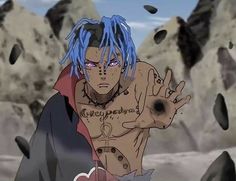 a man with blue hair and tattoos on his chest standing in front of some rocks