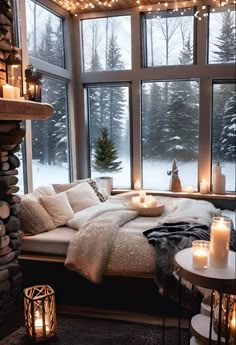 a cozy bedroom with candles on the window sill