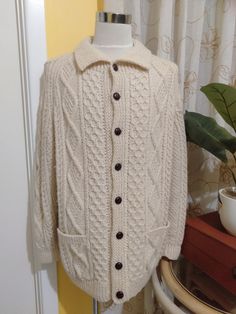 100% Pure Wool Cable Knit Sweater made in The Republic of Ireland. It's Ultra Thick and Warm and in great shape. Would Suit Men's Large Measurements: Collar 26" Across Shoulders 20" Chest 54" Hips 48" Sleeves 26" Long Wrists 10" Two Front Pockets 6" x 6" Length 32" 8 Buttons x .75" Diameter Sweater has a 2" Give (Stretch) Classic White Sweater With Button Closure, Classic Crew Neck Sweater With Button Closure, Classic Cable Knit Polo Sweater, Classic Knitted Cardigan, Classic Cream Outerwear With Crew Neck, Brand Clothes, Fisherman Sweater, Republic Of Ireland, Sweater Making