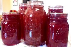 three jars filled with liquid sitting on top of a table