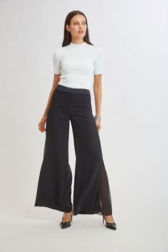 Elevate your style with our modern Crepe Wide Leg Pant. Designed with pleated georgette side panels, this pant offers a sophisticated silhouette and effortless movement. Limited Edition 50th Anniversary Collection Elie Tahari Exclusive Wide Leg Crepe Pants with Side Pleat Detailing 100% Polyester Runs true to Size Measurements: 11.5"L Front Rise, 32.5"L Inseam (approx. length for a size 6) Model is 5'9" and wearing size 2 Dry Clean Only Imported Style #: E903N204 Sleek Evening Dress Pants For Spring, Pleated Pant, Crepe Pants, Jumpsuit Jacket, Long Sleeve Short Dress, Wide Leg Pant, Elie Tahari, Pleated Pants, Knit Tees