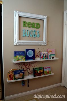 a white shelf with books on it in front of a sign that reads read books