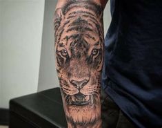 a man with a tiger tattoo on his arm