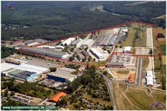 an aerial view of the industrial area with red lines on it and buildings in the background