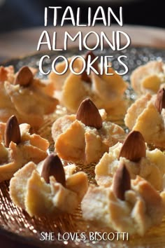 there is a plate with cookies and almonds on the top it says, italian almond cookies she loves biscotti