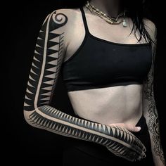 a woman with tattoos on her arms and arm